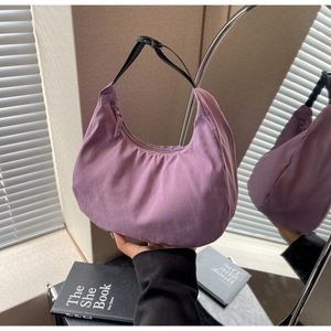 Detail of lavender nylon crescent bag showing smooth zipper and adjustable strap
