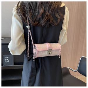 Rear view of a model wearing a pink jacquard cylinder bag with gold chain strap
