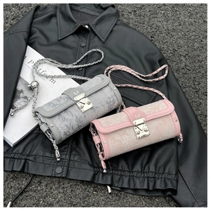 Detail of cylinder chain bags in grey-blue and pink with silver metal M buckles