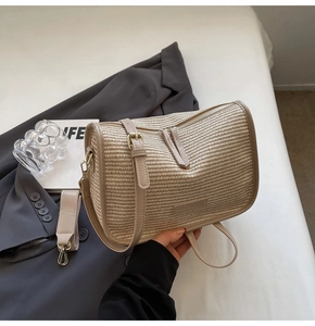 Detailed view of beige woven handbag with faux leather trim and adjustable straps