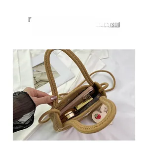Top view of woven straw bag interior showing storage space for phone and makeup items
