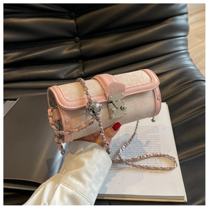Detail of pink and beige jacquard cylinder bag with silver chain and metal M clasp