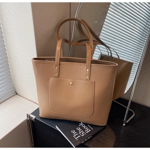 Detail of khaki PU leather tote bag with functional front magnetic pocket and long handles