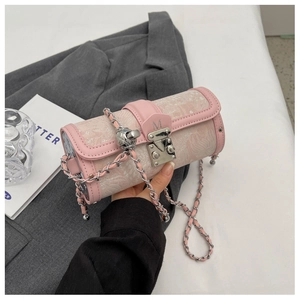 Detail of pink embroidered cylinder bag with silver M buckle and chain strap