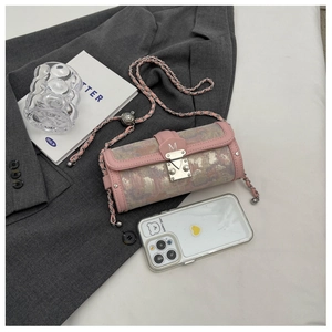 Detail of pink oil painting cylinder bag with chain strap and silver rivet accents