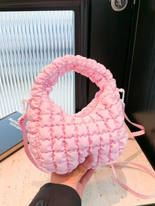 Pink quilted nylon cloud dumpling bag with puffy lattice texture and crossbody strap