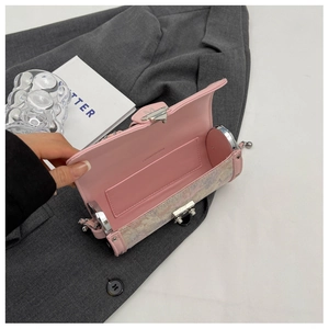 Detailed macro view of the pink glitter cylinder bag interior with a mirror and silver chain