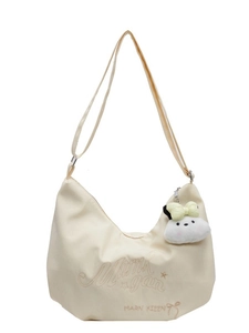 Borsa a tracolla in tela crema con tracolla regolabile e ciondolo a forma di cucciolo