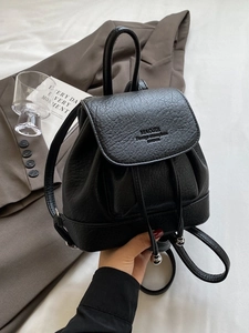 Minimalist black pebble leather backpack with drawstring closure and top handle