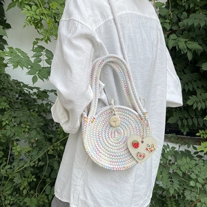 Handmade colorful woven straw round bag with heart charm and crossbody strap