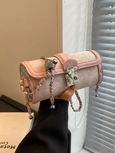 Pink embossed fabric cylinder bag with silver chain strap and metallic ball pendant