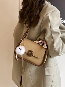 Beige faux leather shoulder bag with chocolate buckle and plush charm detail