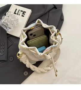 Top view of cream canvas bucket bag interior showing spacious storage and braided handle
