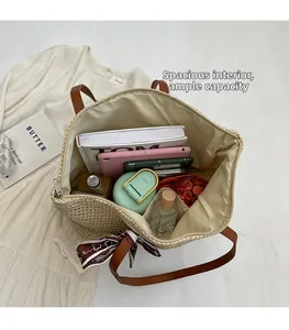 Top view of spacious straw tote bag interior with items and floral scarf detail