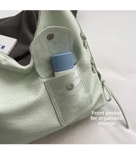 Détail du sac cabas vert menthe avec une poche avant magnétique pour ranger les cosmétiques