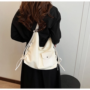 Vue arrière du mannequin portant un sac hobo tissé blanc crème avec cordon de serrage