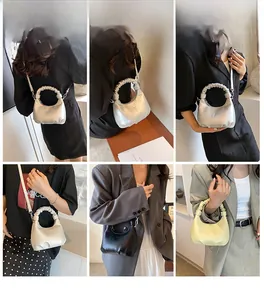 Detailed views of leather dumpling bag with pleated handle in silver, black and beige