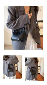 Detail of black crescent hobo bag with pleated cloud handle and silver hardware