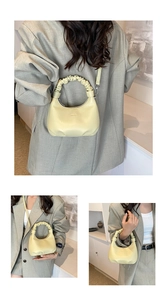 Detail of light yellow dumpling bag featuring a pleated scrunchie handle and smooth PU leather
