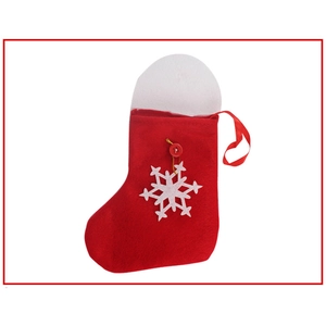 Detail of red Christmas stocking with white snowflake patch and hanging loop