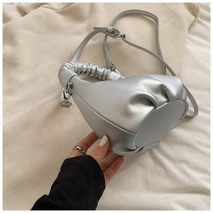 Detailed view of silver dumpling bag with metallic texture and pleated handle