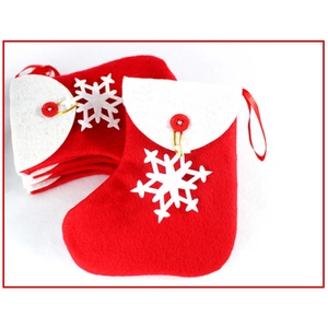 Detail of red Christmas stockings with white snowflakes and decorative buttons for tree hanging