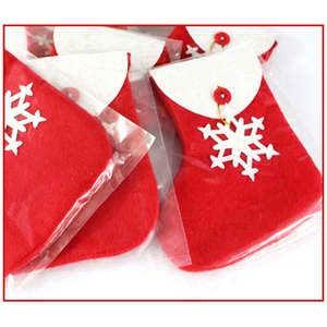 Close-up of red and white felt Christmas gift bags with snowflake and button detail