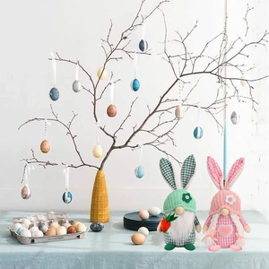 Detailed festive scene of handmade Easter gnomes with rabbit ears and carrot accessories