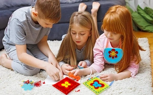 Kids DIY felt sewing kit with colorful precut sheets and safety tools in home scene