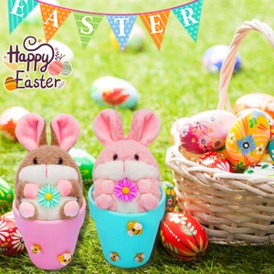 Detail of plush Easter bunnies in ceramic pots with daisies and bee accents