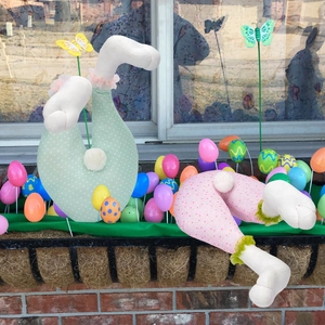 Detailed view of Easter bunny butt floral stakes in pink and green polka dot fabric