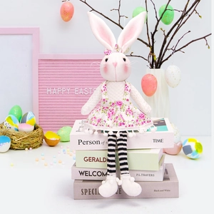Detailed view of an Easter bunny plush doll with striped legs and floral dress