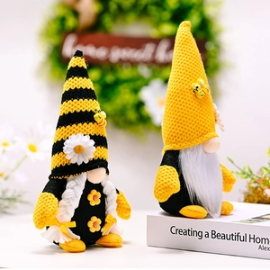 Detail of bee themed gnome plush set with striped hats, white braids and floral accents