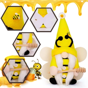Close-up of handmade bee gnome with daisy hat, white wings and wooden honey dipper tool