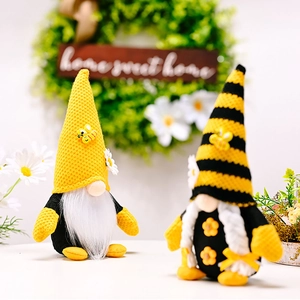 Close-up of two bee festival gnomes with yellow knitted hats and white plush beards