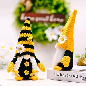 Detail of bee gnomes with knitted hats and daisy accents for home festival decor