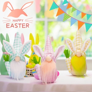 Close-up of Easter gnomes with rabbit ears, long beards and carrots for home decoration