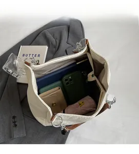 Interior view showing large capacity of the beige tote bag with daily essentials inside