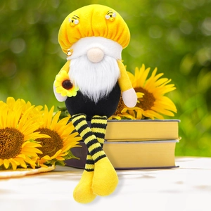 Close-up of a sunflower bee gnome with striped long legs resting on books in a garden