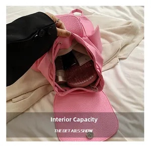 Internal view of the pink lychee leather backpack showing large storage capacity