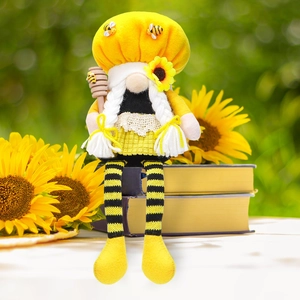 Detail of bee gnome plush with sunflower hat, white braids, and a wooden honey wand