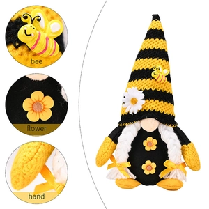 Detail view of the bee gnome showing knitted hat, yellow flowers and white braided hair