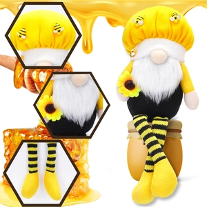 Detail showing plush bumblebee gnome with sunflower and striped long legs on honey jar