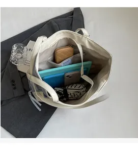 Top view of the spacious inner compartment and pocket of the beige faux leather tote bag