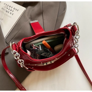 Top view of red patent leather bag showing interior storage capacity and silver rivets