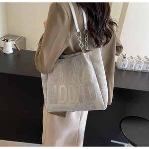 Detail of silver pleated tote bag with HOOTO logo stitching and metal chain strap