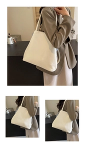 Detailed view of white leather tote bag showing spacious interior and sleek minimalist design