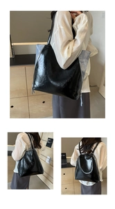 Detail showing the contrast material stitching and side zipper on this large tote bag