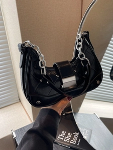 Glossy black quilted shoulder bag with silver chain and rivets for a modern look