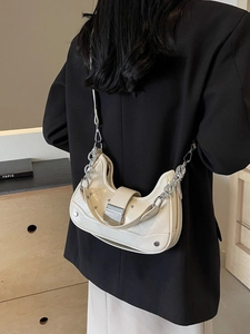 Creamy crescent moon hobo bag in glossy leather with silver buckle and chain strap